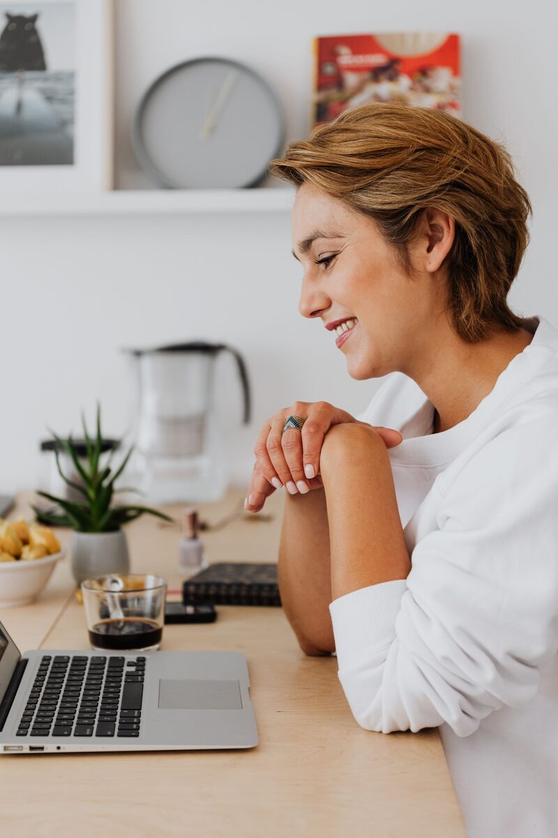 Woman smiling at laptop